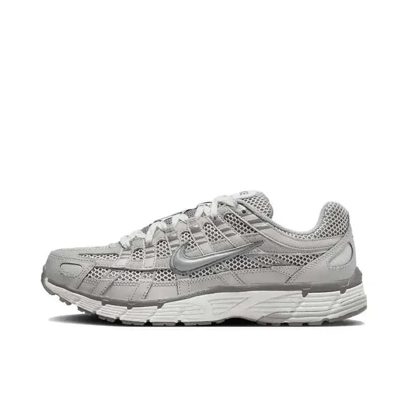 Nike P-6000 Unisex vintage retro running sneaker in black, metallic silver, and white with breathable mesh upper and cushioned midsole.