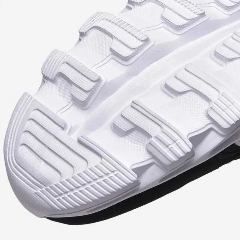 Close-up of white 2025 New Men's & Women's Running Shoes with durable anti-slip outsole design
