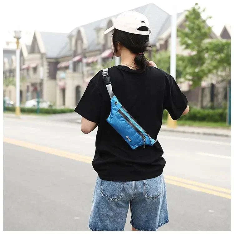 Unisex blue nylon waist and chest bag worn across the back for casual sports and travel use