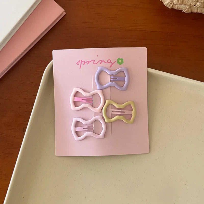 Set of 4 cute colorful geometric mini hair clips on pink card for kids