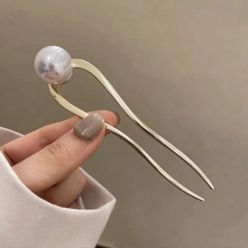 Elegant gold U-shaped hairpin with large pearl accent for stylish hair buns and updos