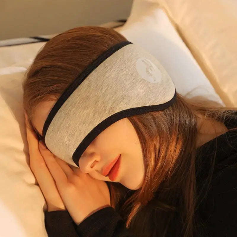 Woman resting with adjustable eye mask and noise-reducing sleep earplugs for total light and sound blockout
