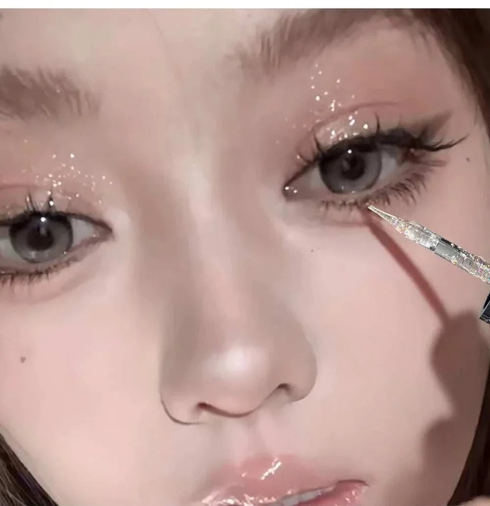 Close-up of a person applying Balletism Liquid Eyeshadow with fine shimmer glitter near the eye for a radiant, delicate highlight effect.