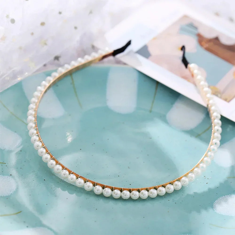 Modyle Full Pearl Hairband with elegant floral pearls and elastic fit on blue plate