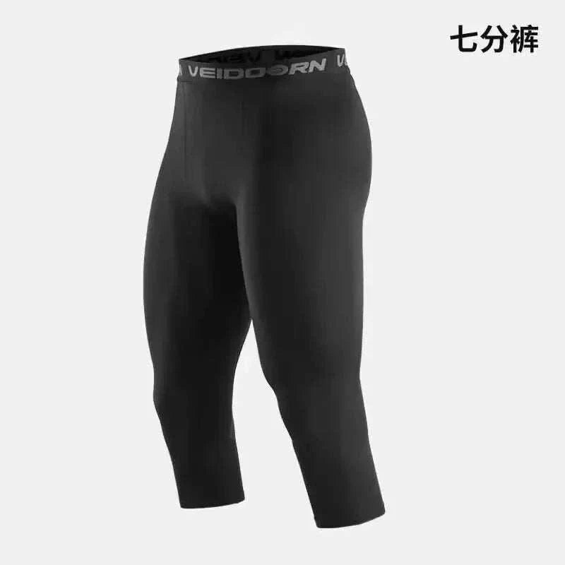 Men’s black compression workout tights with three-quarter length and breathable, sweat-wicking fabric for enhanced performance and comfort.