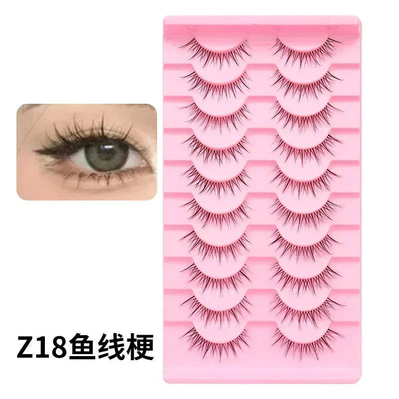 10 pairs of Natural Manga Full Strip Lashes with anime-inspired design, natural volume, and reusable lightweight synthetic fibers in a bulk pink tray