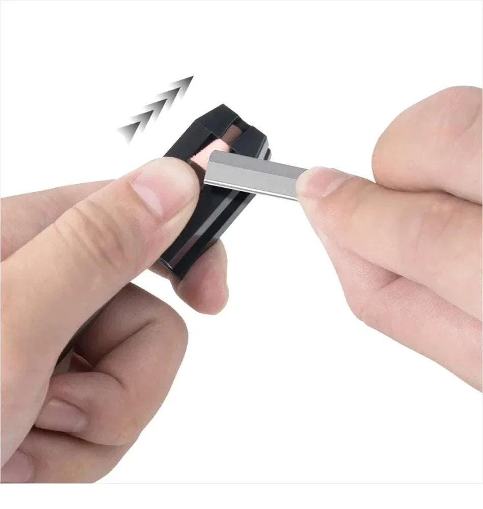 Hand inserting a precision blade into a compact eyebrow trimmer from the Eyebrow Pencil & Trimmer Set grooming kit