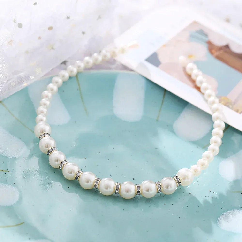 Modyle Full Pearl Hairband with elegant floral pearls and elastic fit on blue plate