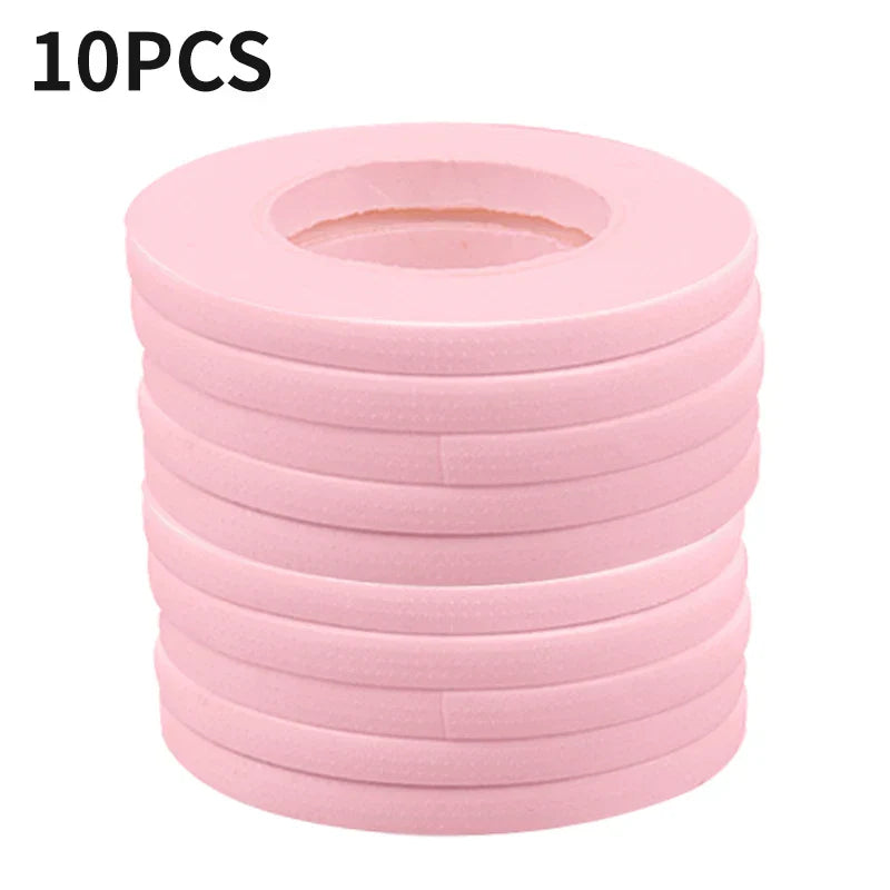 Stack of 10 pink micropore eyelash extension tapes for gentle, breathable lash application