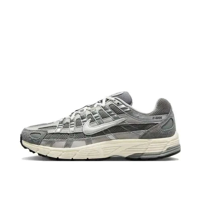 Nike P-6000 Unisex casual running sneakers in black, metallic silver, and white with breathable mesh upper and cushioned midsole.