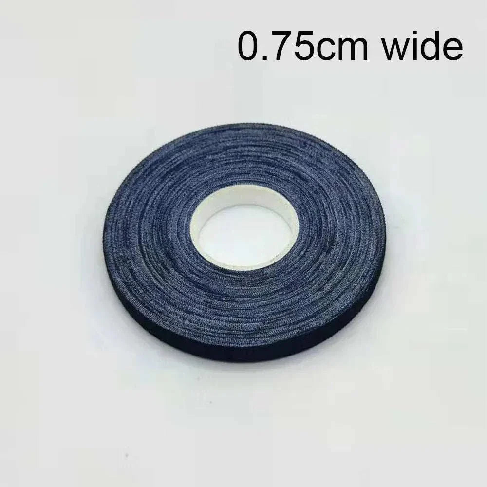 Jiu-Jitsu Bandage elastic finger tape roll, 0.75cm wide, black self-adhesive sports tape for joint protection and grip support in martial arts.