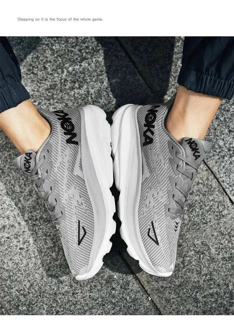 Gray unisex running shoes with carbon plate air cushion technology and breathable mesh upper on pavement