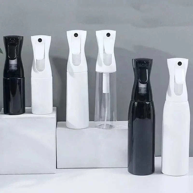 Set of black and white high pressure mist spray bottles in various sizes for continuous fine mist application