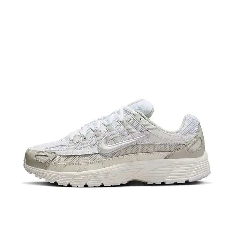 Nike P-6000 unisex casual running sneakers in white and metallic silver with breathable mesh upper and cushioned midsole.