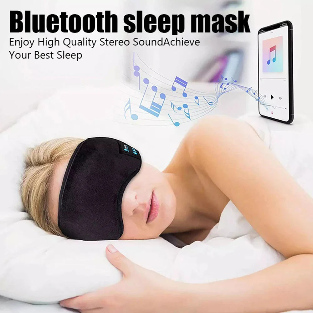 Woman wearing Fone Bluetooth Earphones sports sleeping headband mask lying on bed with smartphone playing music.