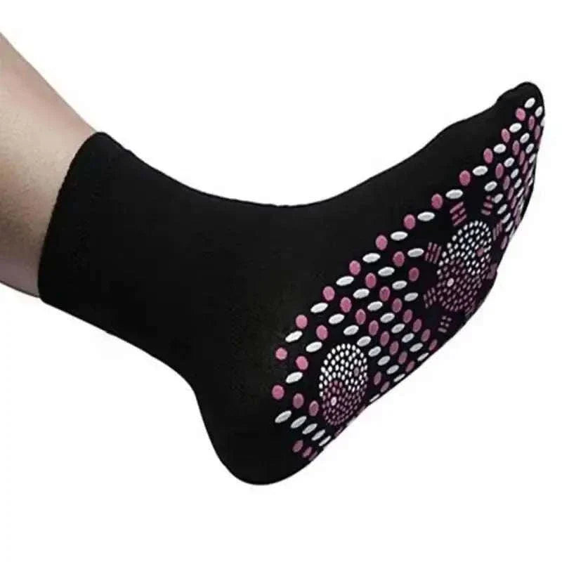 Black non-slip personal health care sock with pink and white grip dots on the sole