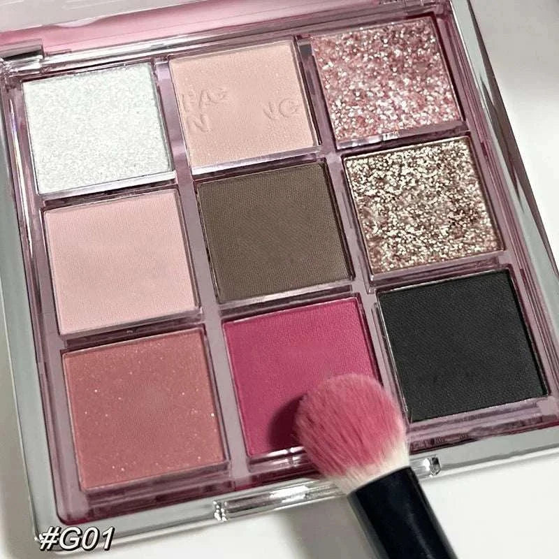 9 Colors Eyeshadow Palette with matte, glitter, and neutral shades in a compact case with pink brush