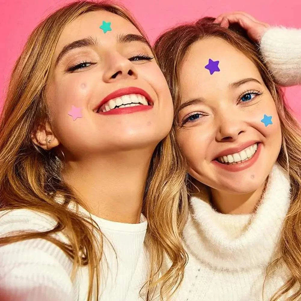 Two smiling women wearing colorful star-shaped pimple patches on their faces against a pink background