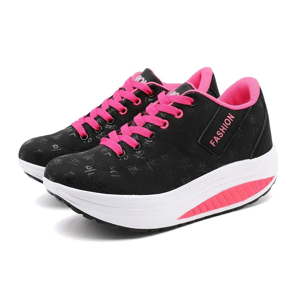 Black and pink breathable wedge heel sneakers with lace-up closure and cushioned sole for comfort and style