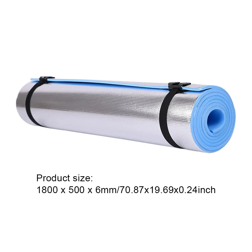 Rolled non-slip yoga mat with blue underside and silver top, secured with black straps, measuring 1800x500x6mm