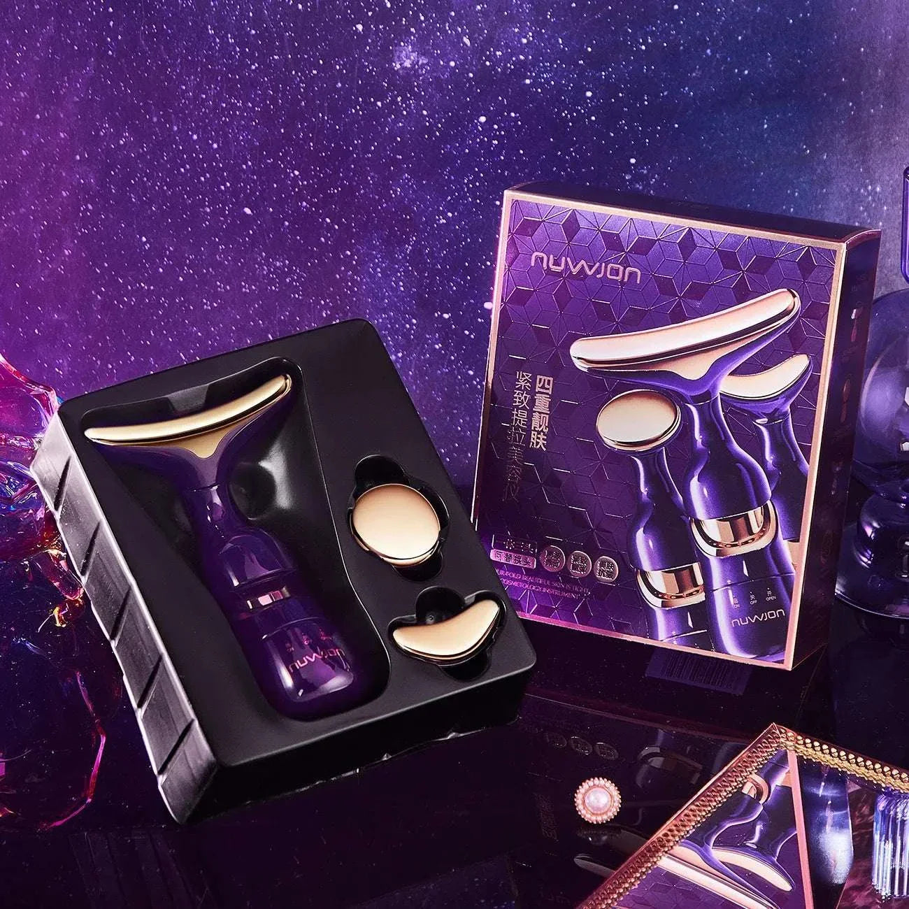 3-in-1 facial lifting device with EMS microcurrent technology for face, neck, and eye massage in purple and gold tones with packaging box on a reflective surface