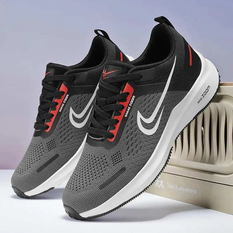 Pair of men's lightweight running shoes with breathable mesh, flexible design, and non-slip rubber outsole in black, gray, white, and red accents.