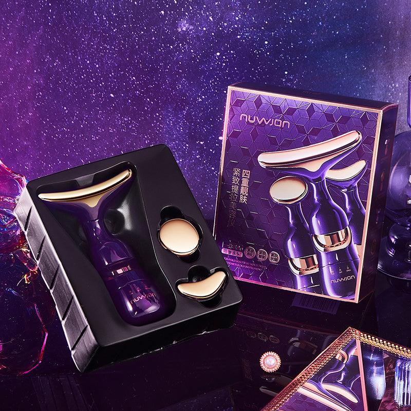 Purple 3-in-1 Facial Lifting Device with gold edges and two attachment heads in black packaging next to matching product box
