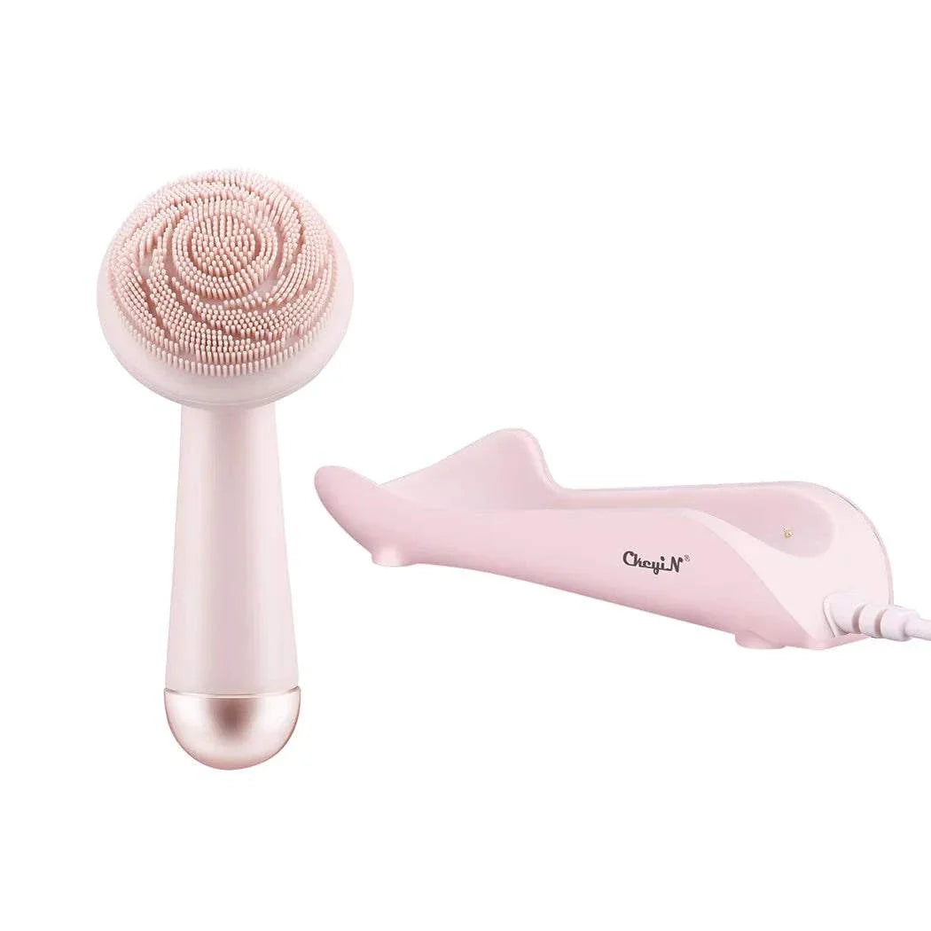Pink electric silicone facial brush with soft bristles and a charging dock for deep pore cleansing and massage