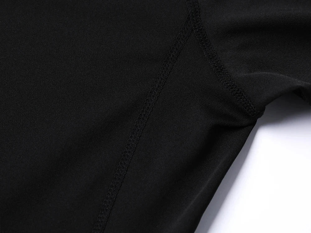 Close-up of black Anime Jujutsu Kaisen compression t-shirt fabric and stitching.