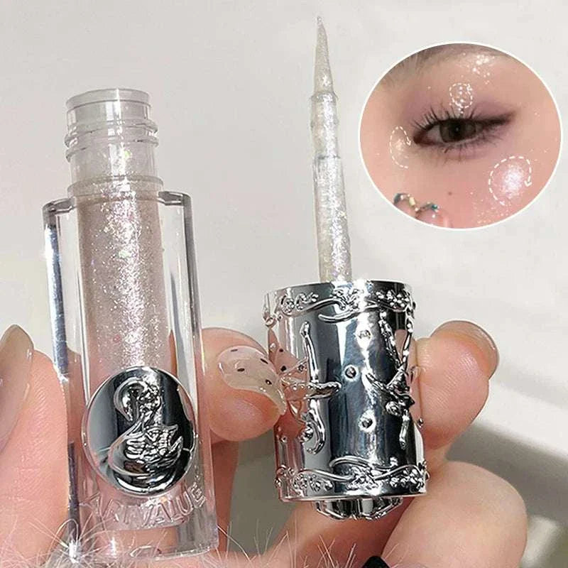 Balletism Liquid Eyeshadow with fine shimmer in clear tube and detailed silver cap, highlighting eyelids with delicate radiant shimmer and smooth application.