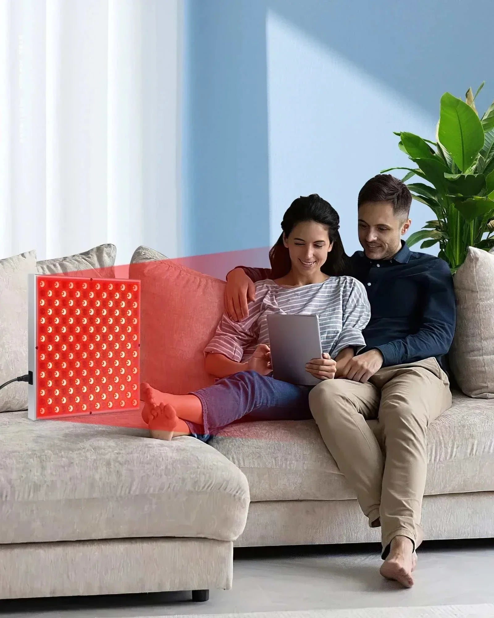 45W LED red light therapy panel emitting red light near a couple relaxing on a sofa at home