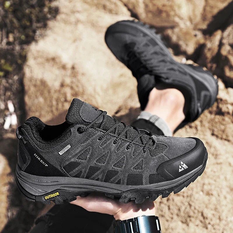 Black HIKEUP men's hiking shoes with durable grip soles designed for rugged outdoor terrain and comfort.