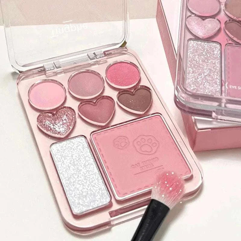 8-color pink orange eyeshadow palette with heart-shaped blush and highlighter, featuring matte, shimmer, and glitter shades in a compact case with a brush.