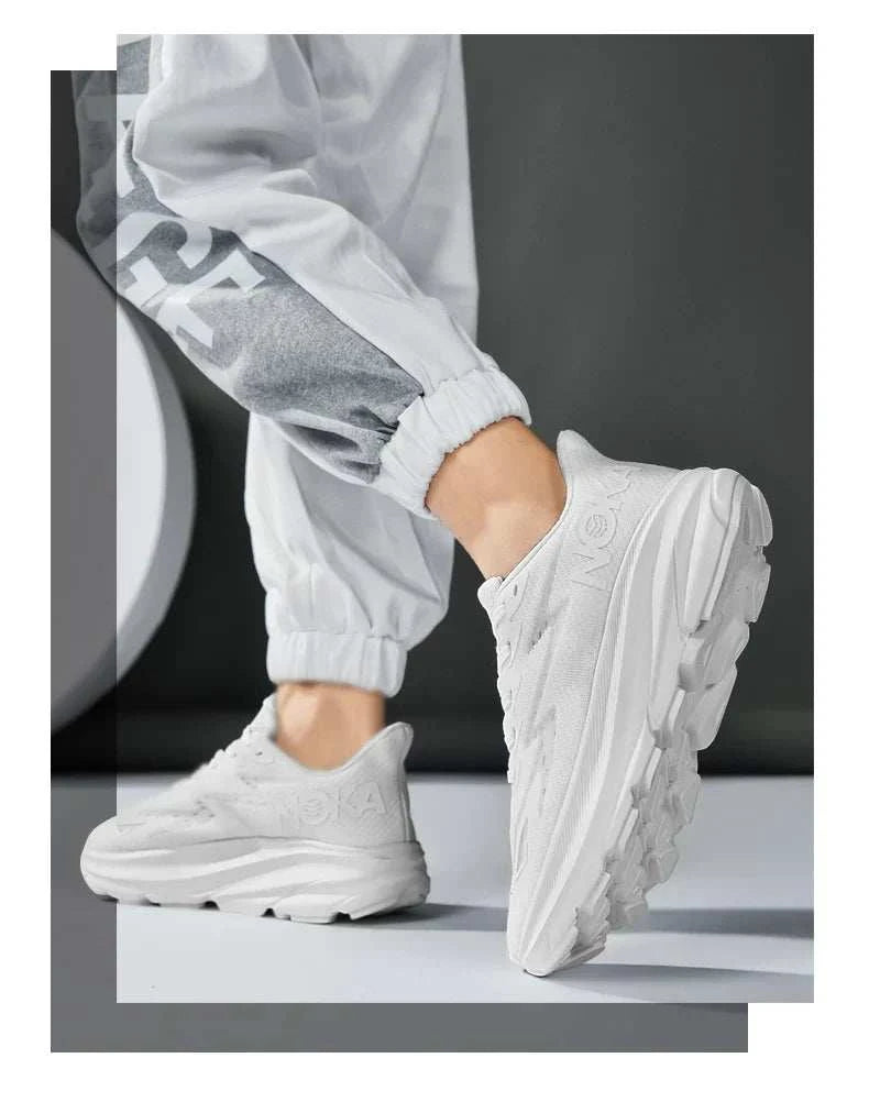 White Carbon Plate Air Cushion running shoes with breathable mesh upper and durable rubber outsole worn with grey and white jogger pants