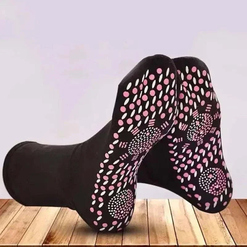 Non-slip black socks with pink and white grip dots for personal health care and safety.